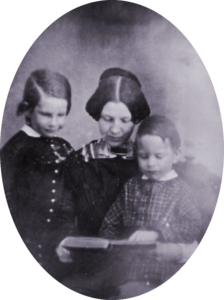 Fanny Longfellow with two of their sons, reading a book, circa 1849. 
