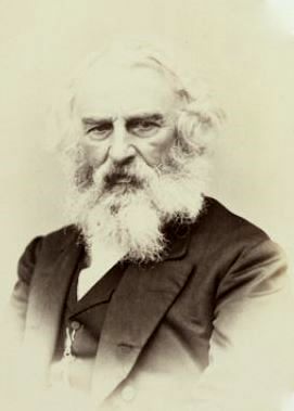 Henry Wadsworth Longfellow looking directly at the camera, with white hair and a beard.