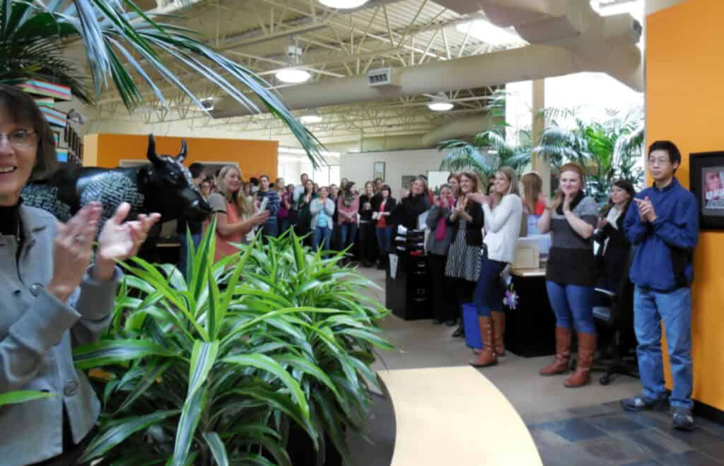 The light-and-plant-filled, spacious atrium of the Sourcebooks main office in Naperville, Illinois - a space known by staffers and authors alike as the Bullpen - is lined on both sides by publishing team members applauding the arrival of Susanna Kearsley, who is taking the photograph, so remains off camera.